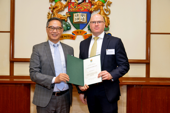 Mr. Ben Burley (right) receiving a Certificate of Appreciation from Ir. Ricky Lau, JP (left)